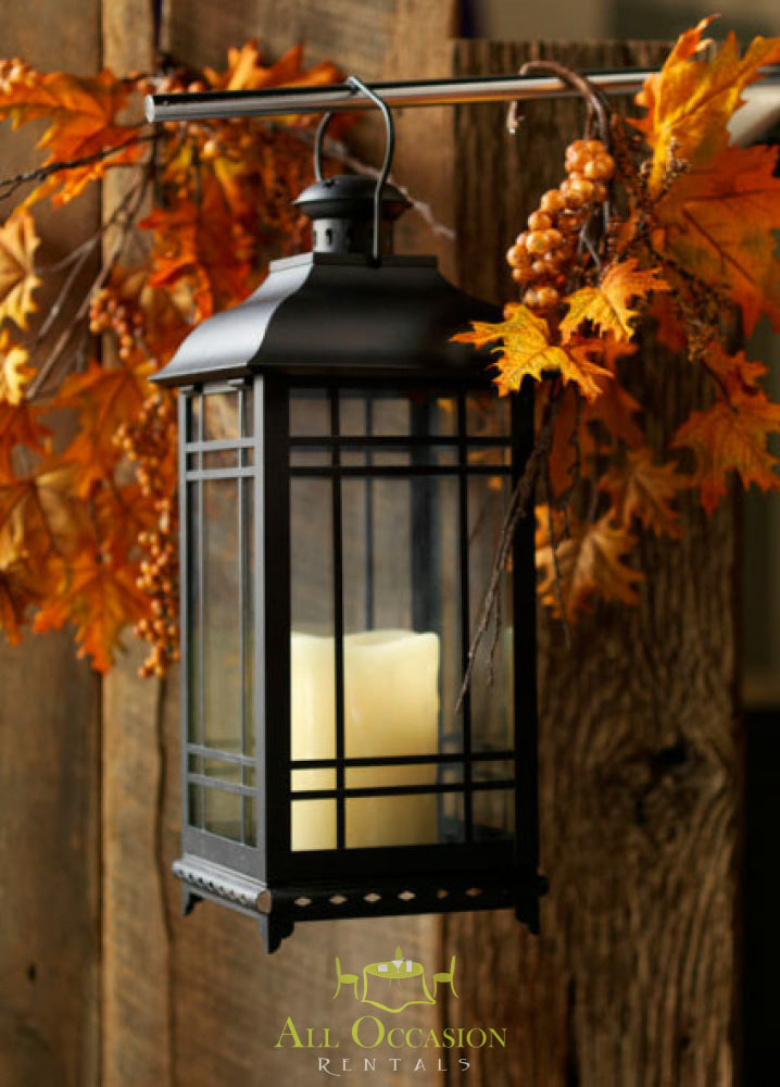 Black metal lantern with candle, ideal for Corona event rentals and vintage decor for weddings and parties.