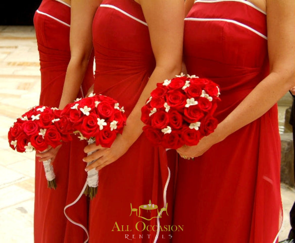 Bridesmaids in red dresses holding beautiful Bouquets Flowers with red roses and white accents.