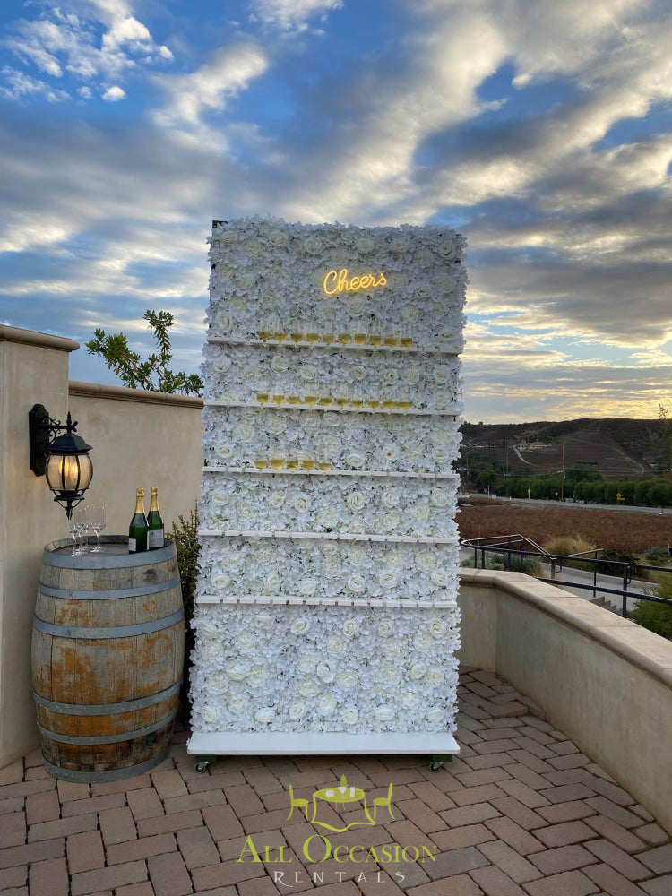 Elegant Champagne Wall rental with floral display and shelves for drinks, perfect for special events and celebrations.