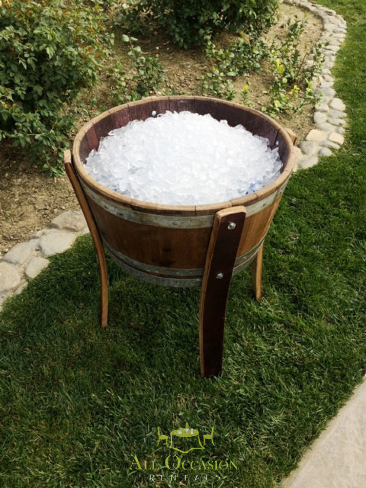 Wine barrel ice chest filled with ice for outdoor events, perfect for Corona party rentals and banquet table rentals.