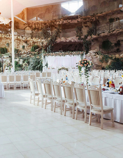 Elegant indoor reception setup with banquet tables and chiavari chairs for Corona event rentals.