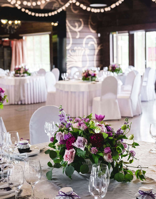 Elegant indoor event setup with floral centerpieces, perfect for Corona event rentals and wedding accessories rental.