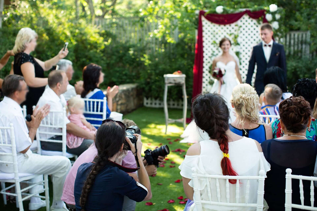 Wedding ceremony in a garden setting, capturing the joy and celebration of newlyweds. 10 Things Not to Do on Your Wedding Night.