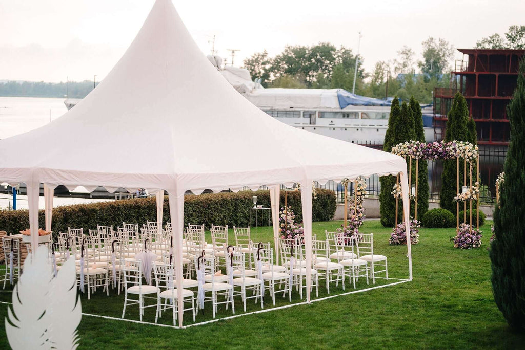Tent rentals for any events featuring a white wedding tent set up for a reception.