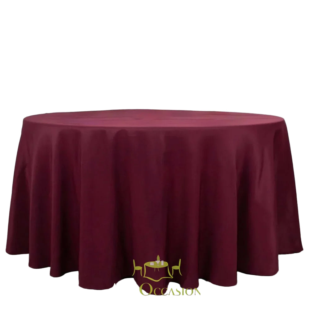 132 Inch Round Polyester Tablecloth Burgundy draped elegantly over a large round table, perfect for all occasions.