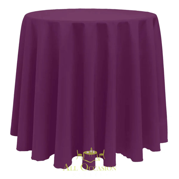 132 Inch Round Polyester Tablecloth Plum draped over a round table for elegant events and occasions.