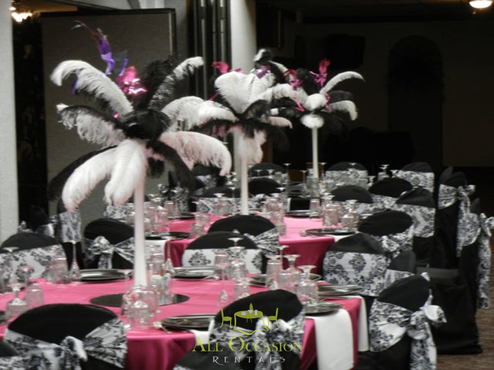Elegant feather centerpieces with black and pink decor for Corona event rentals.