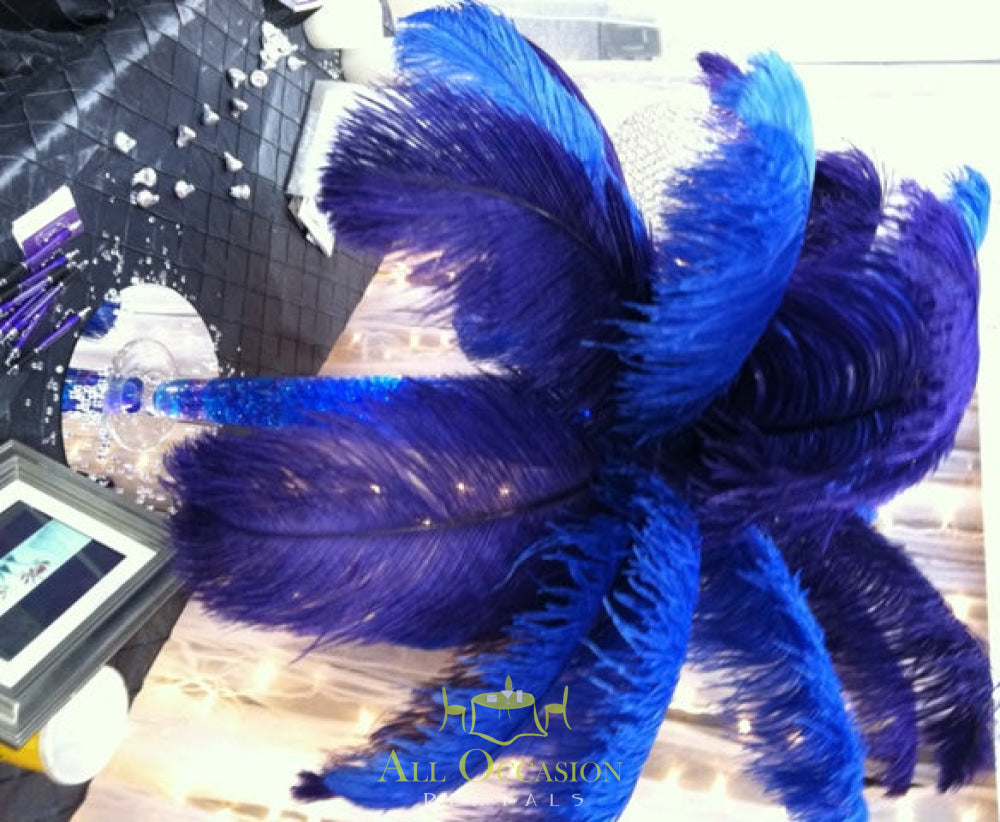 Elegant blue feather centerpiece for event table, ideal for Corona party rentals and wedding accessories rental.