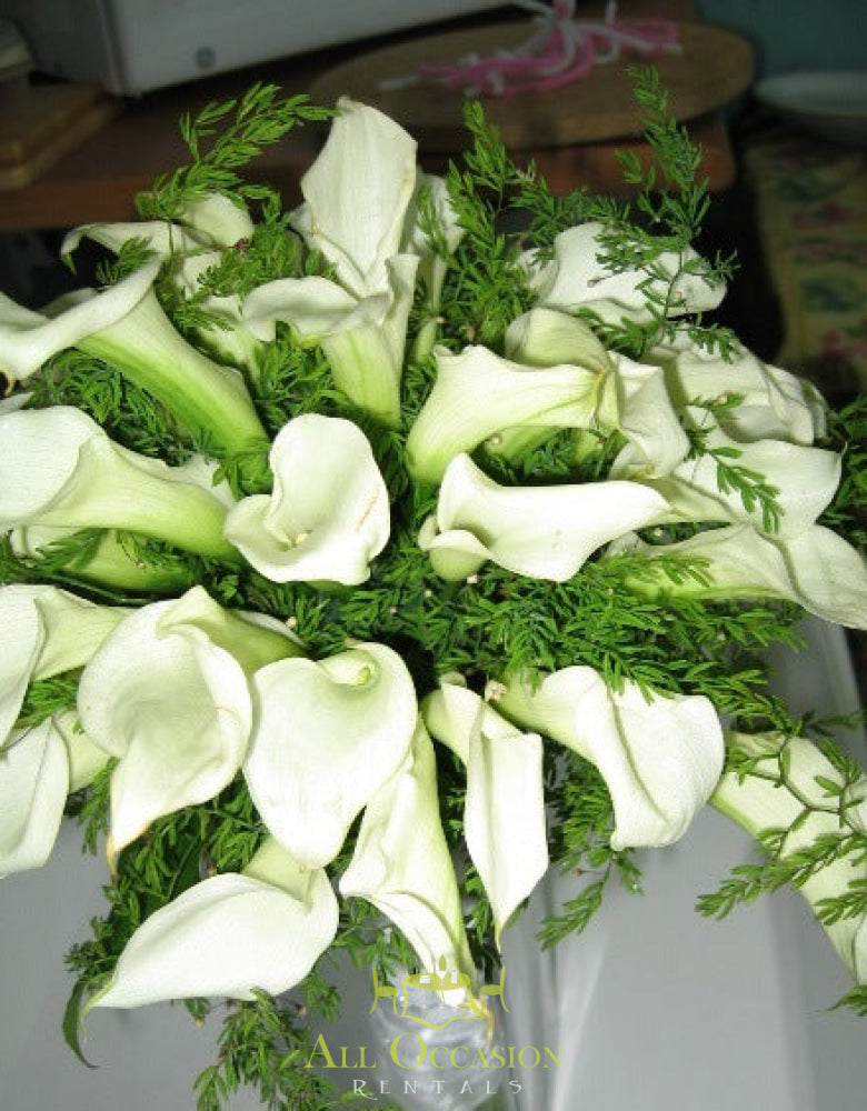 Elegant wedding bouquet of white calla lilies for event rentals in Corona, perfect for any special occasion.