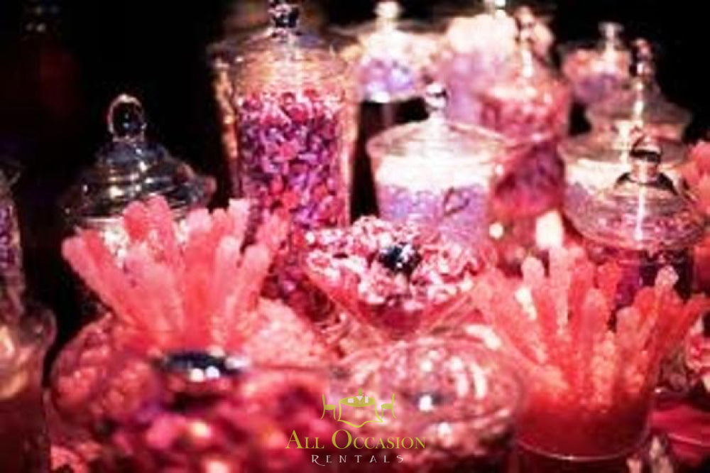 Candy buffet rental in Corona with jars of pink candies, ideal for events, weddings, and parties.
