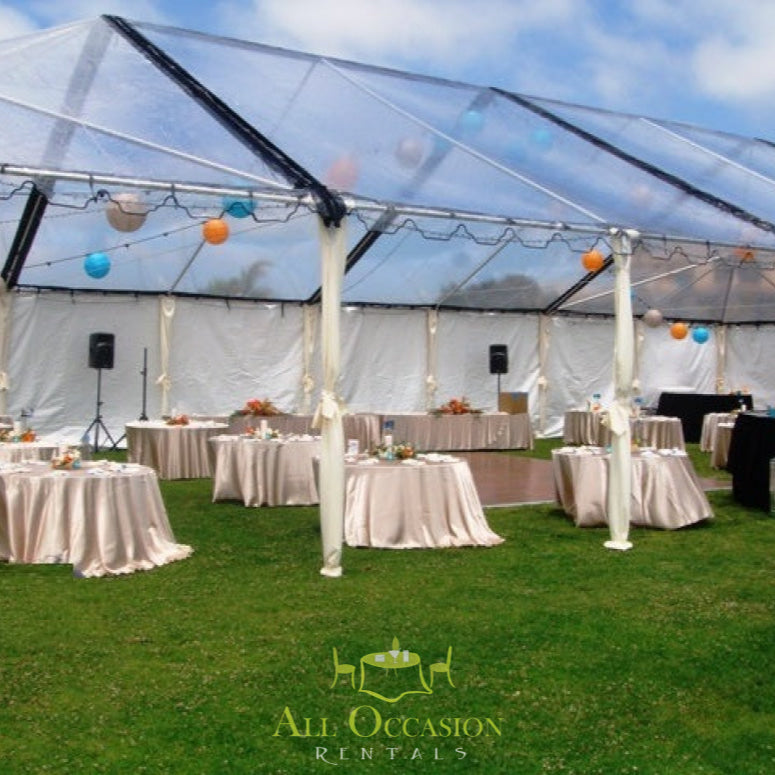 Elegant outdoor tent setup for event with draped tables and decorative lighting, perfect for Corona event rentals.