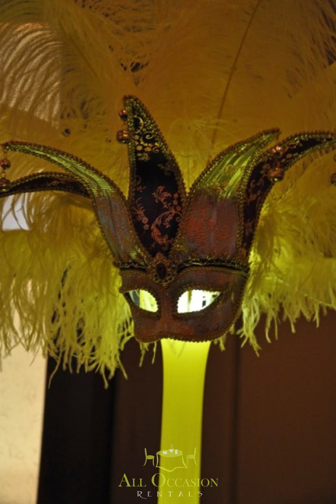 Colorful feather centerpiece with masquerade mask for Corona event rentals and party decor.