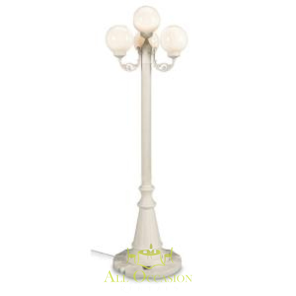 Elegant 8' white lamp post with three globe lights, perfect for outdoor events and Corona party rentals.