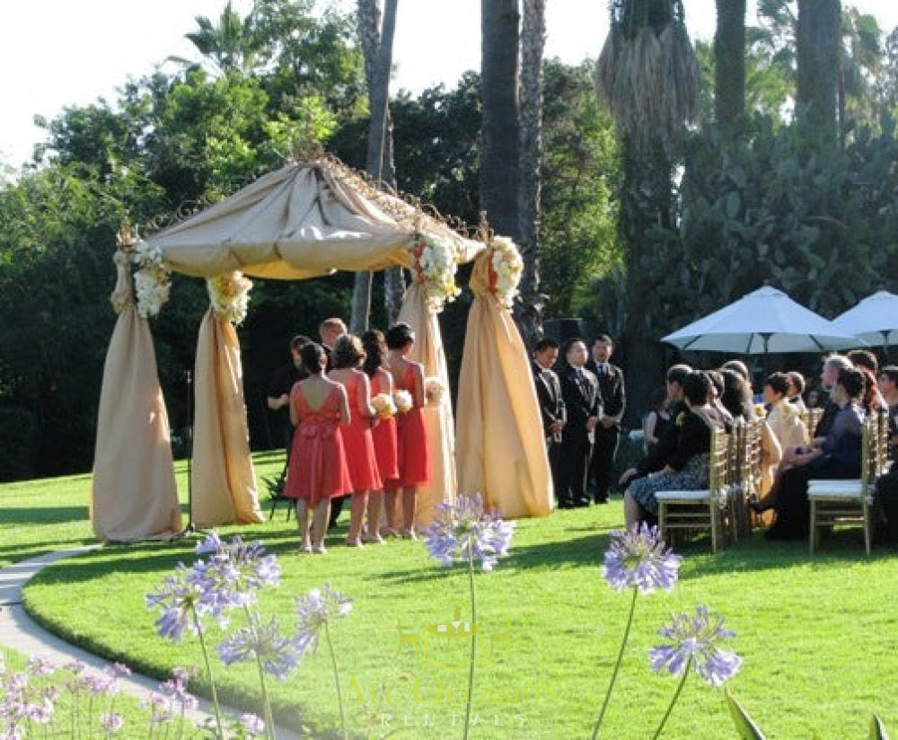 Iron square arch with ivory draping for outdoor wedding, perfect for Corona event rentals and Indian wedding rentals.