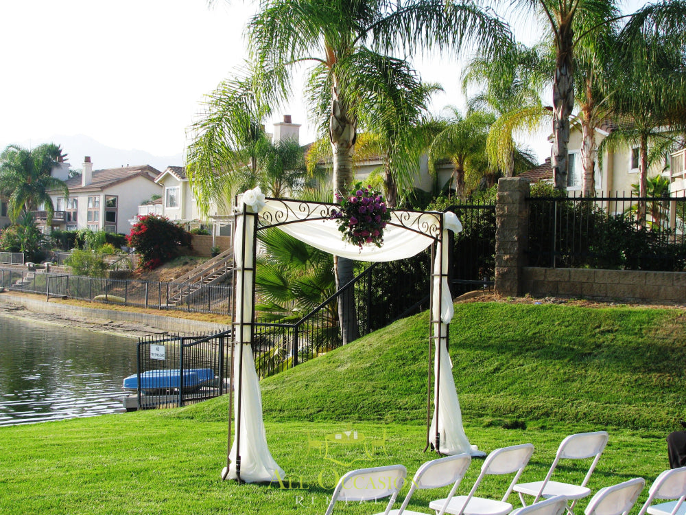 Iron square arch with draping and floral decor for weddings in Corona, part of event rentals in Inland Empire.