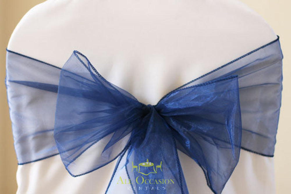 Navy blue organza sash tied on chair, perfect for event rentals in Corona, enhancing wedding and party decor.