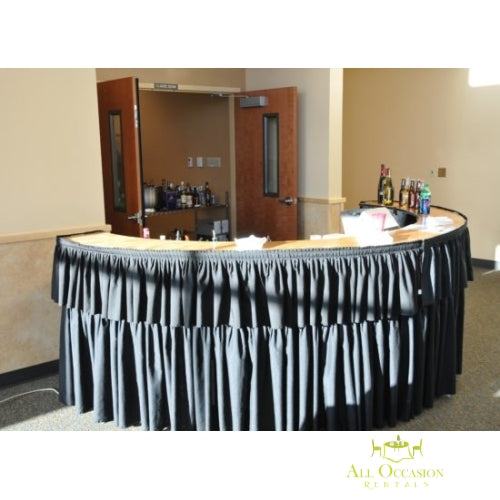 Sepentine bar with black draping for Corona event rentals, ideal for parties and weddings.