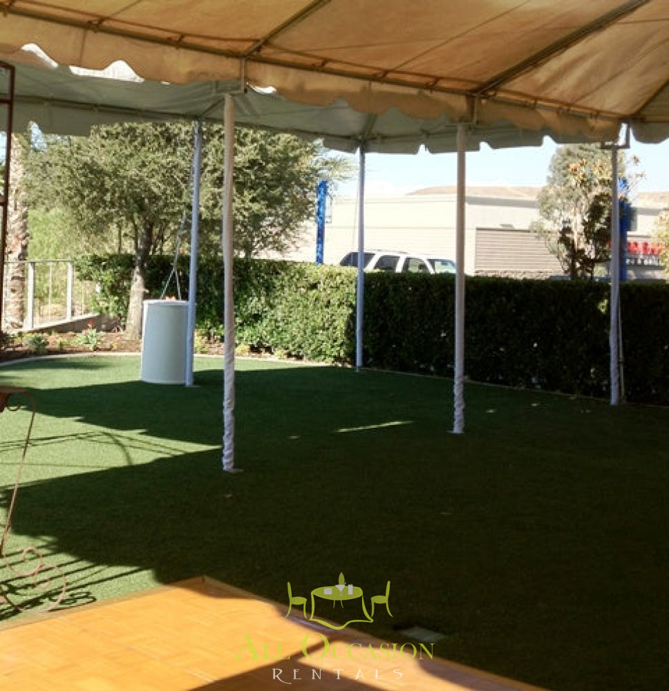 Spacious outdoor event tent rental in Corona with green grass and clear surroundings.