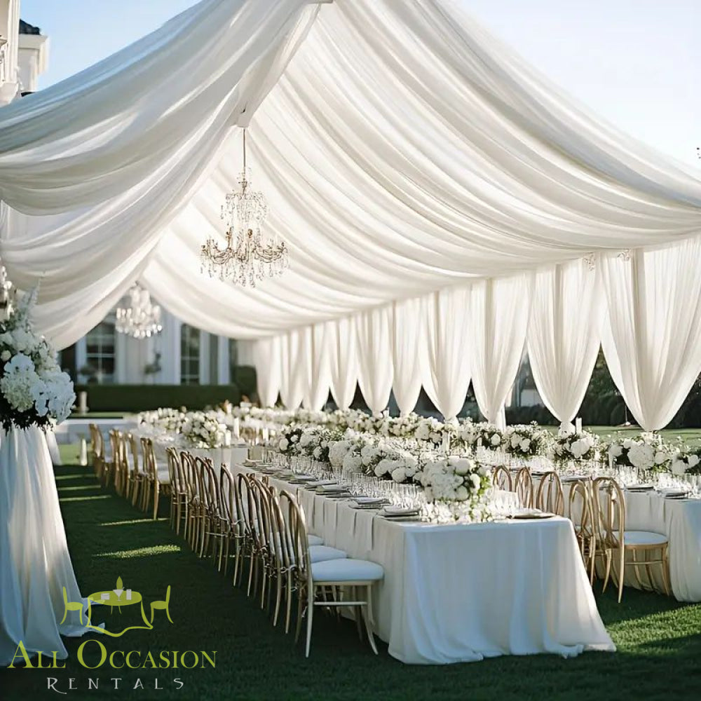 Elegant tent setting featuring a Tent Liner 10' x 50' Rental with chandeliers and floral decor for upscale events.