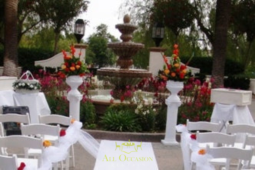 Elegant wedding columns adorned with flowers, perfect for outdoor ceremonies in Corona, CA. Event rentals available.