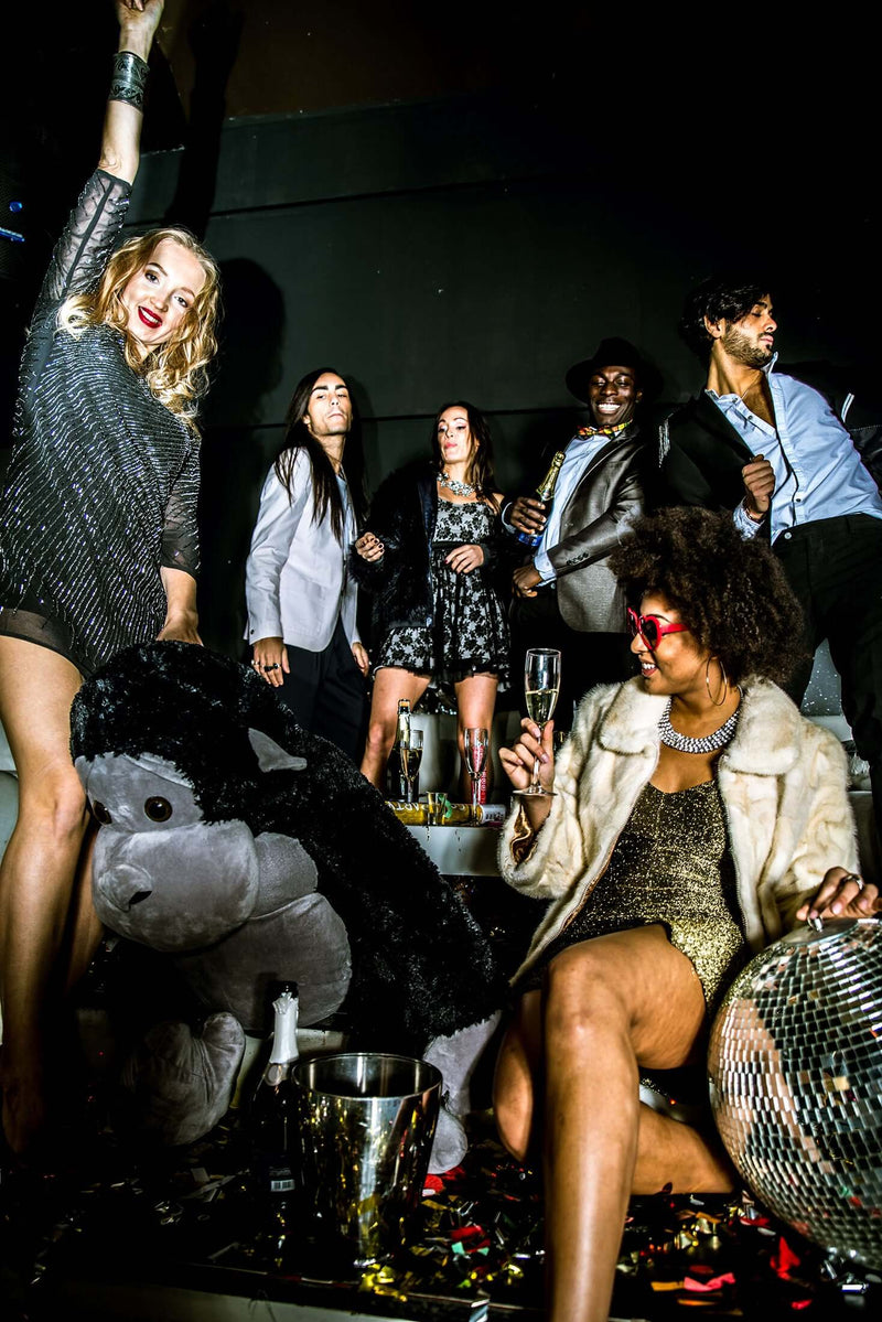 Guests celebrating at a 70s-themed party with festive décor