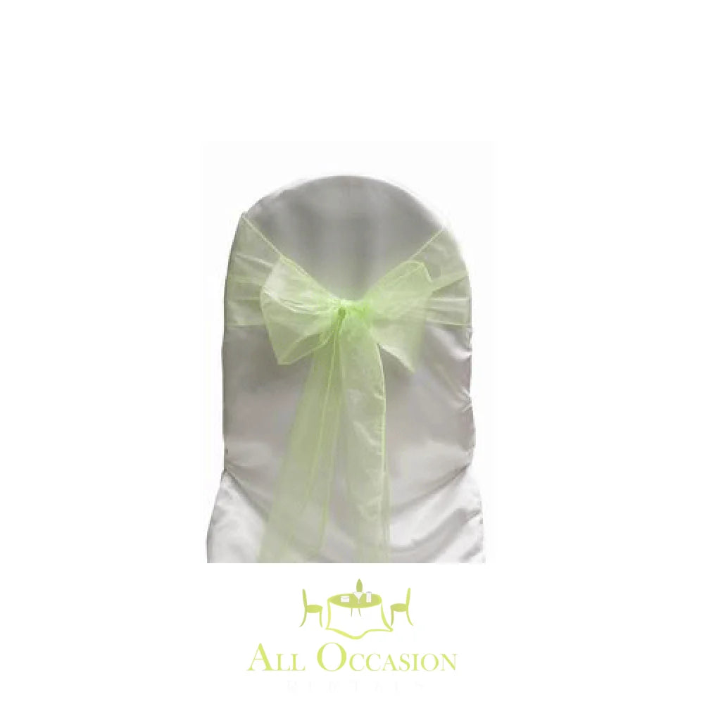Organza sash in lime color tied on a white chair cover for event rentals in Corona.