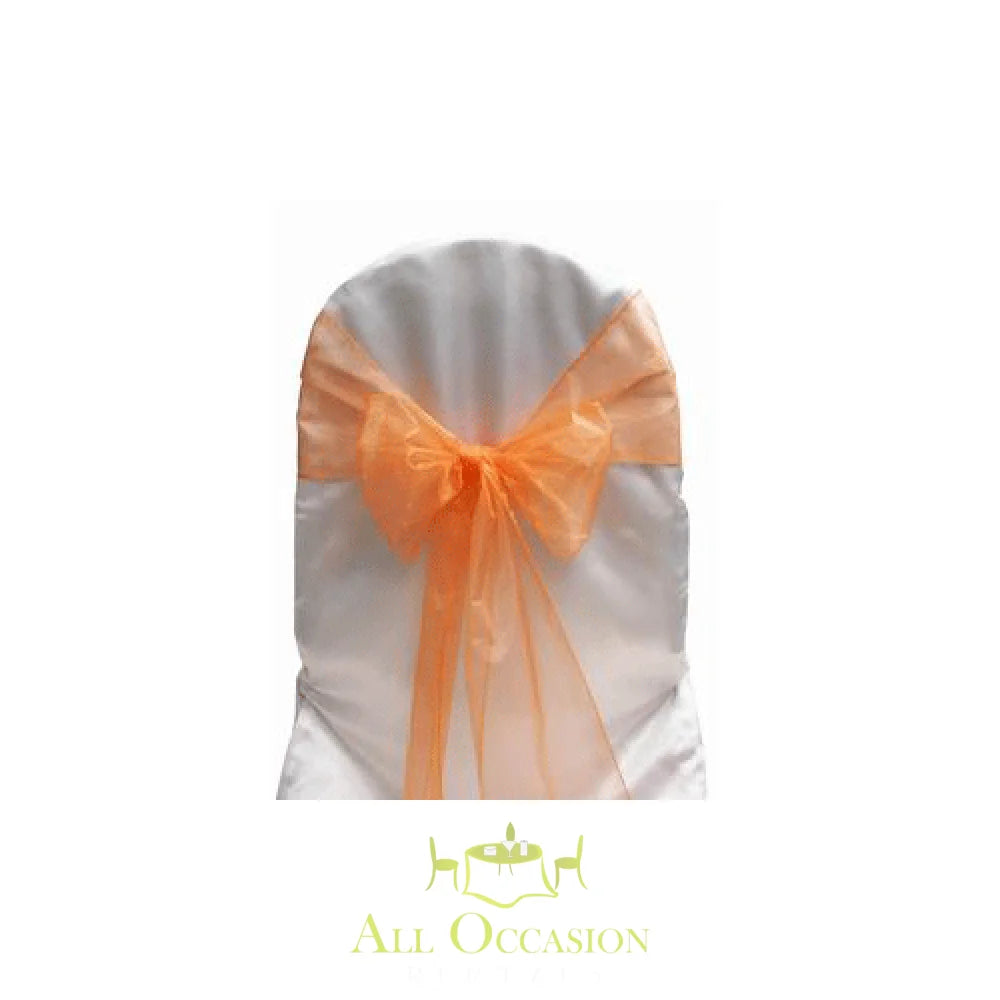 Orange organza sash on a white chair, perfect for event decor rentals in Corona and the Inland Empire.