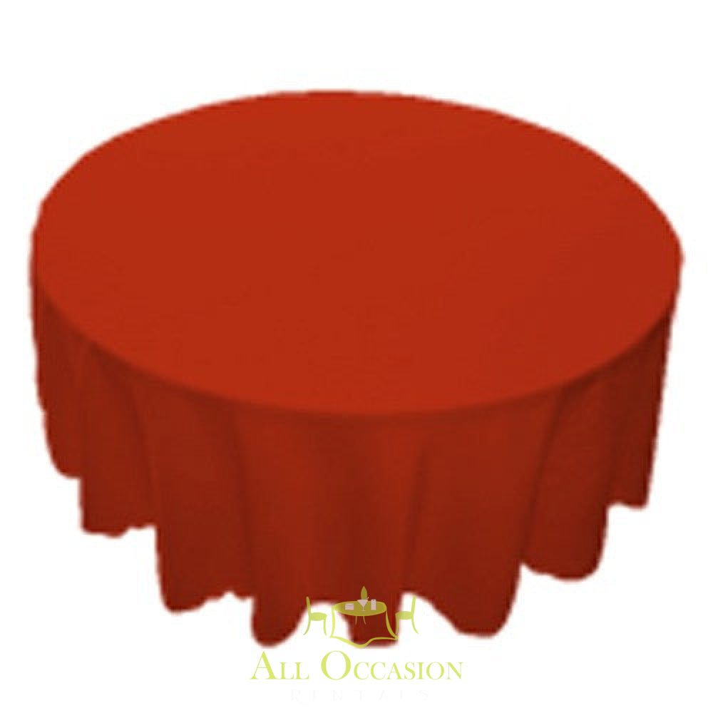 Red 120 inch round polyester tablecloth for events and weddings, perfect for table linen rental in Corona.