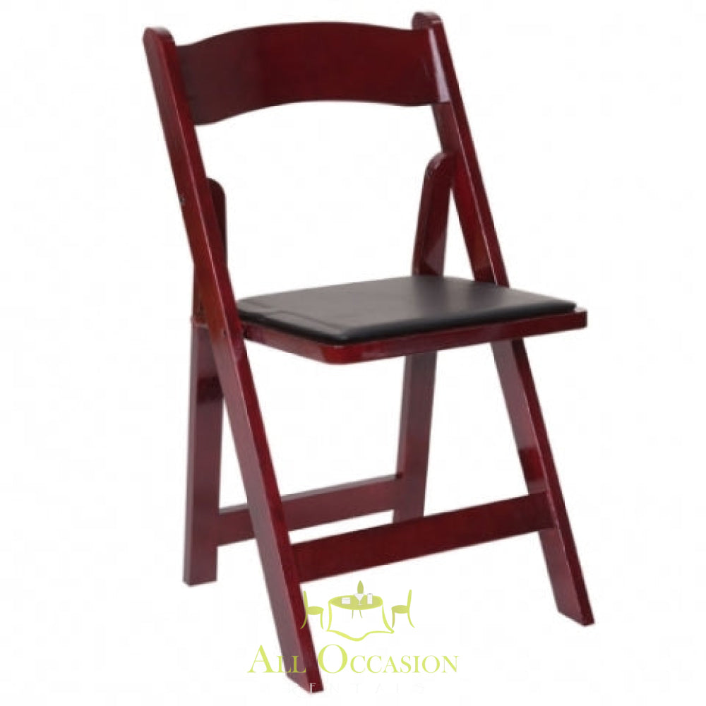 Wood mahogany folding chair with padded seat for Corona event rentals, ideal for weddings and parties.